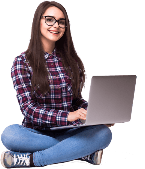 a woman wearing glasses sits on the floor with a laptop in front of her
